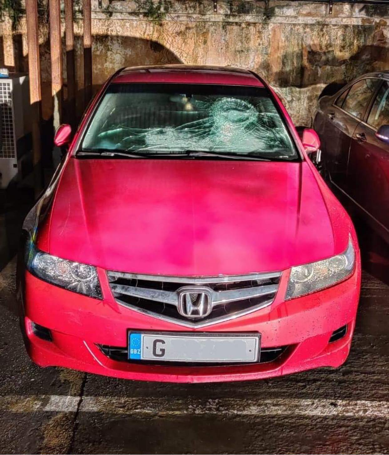 The Honda Accord motor car with a damaged windscreen following the collision with an RGP patrol vehicle.